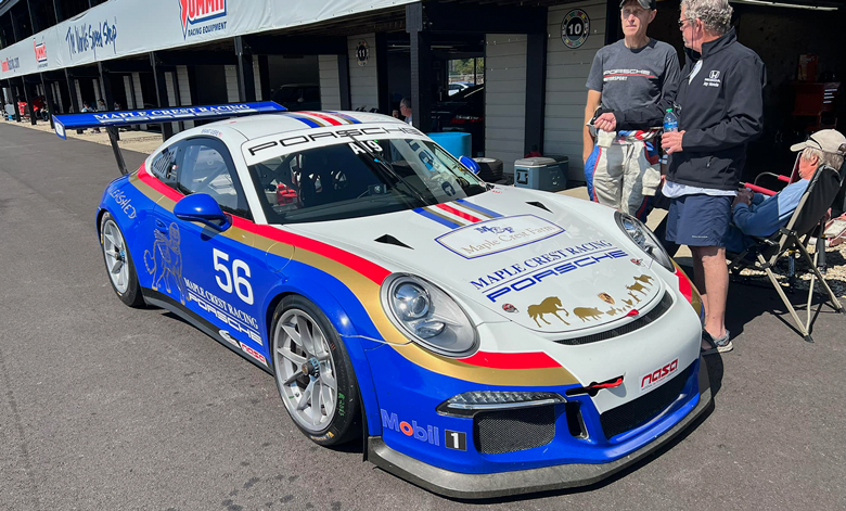 Porsche 911 991 Cup race car with custom Maple Crest Racing livery design inspired by Rothmans Paris Dakar style in blue red and gold motorsport colors